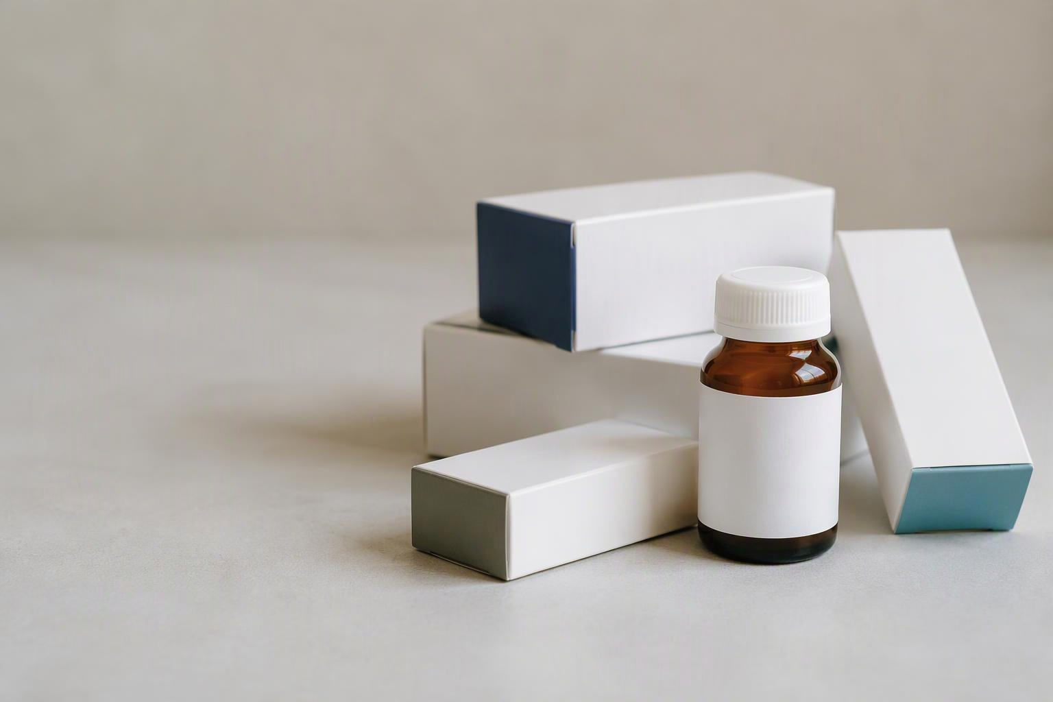 Caixas genéricas e frasco fechado de medicamento sobre uma superfície neutra.